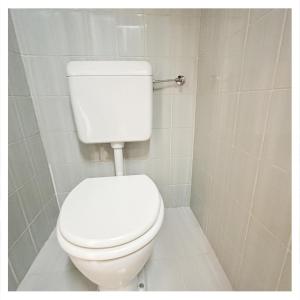 a bathroom with a white toilet in a stall at Studio Homebase in Spittal an der Drau