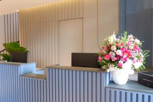 a bouquet of flowers on a counter in an office at The Artha - Bandung in Bandung