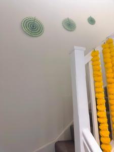 a staircase with yellow decorations on the wall at Redheema in Lower Sydenham Station