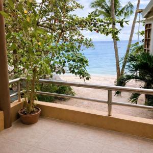 a balcony with a view of the beach at Iwayan Beach Resort in Panglao Island