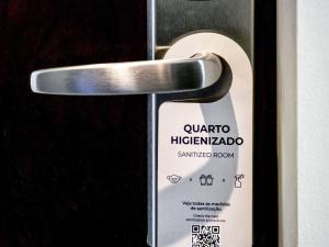 a door opener with a sign on it at Pullman Sao Paulo Guarulhos Airport in Guarulhos