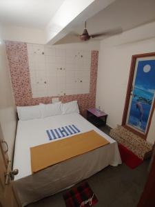 En eller flere senge i et værelse på Ambai Guest House