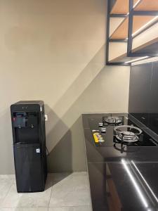 a kitchen with a stove and a black counter top at ABD Home Blitar syariah at Blitar City in Blitar