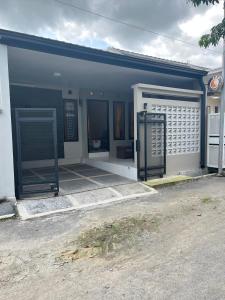 a small house with a gate and a door at ABD Home Blitar syariah at Blitar City in Blitar