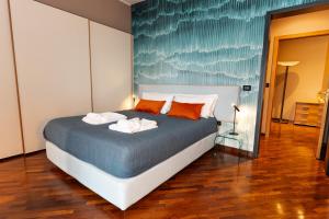 a bedroom with a bed with two towels on it at Apulia Re' Aparthotel & Suites in Bari