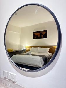 a bedroom with a large circular mirror on the wall at Nasai Retreat Studio in H Elite Design Building in Kota Bharu +21 photos