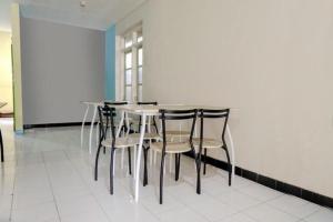 a dining table and chairs in a room at FIVE HOTEL Sarangan in Sarangan
