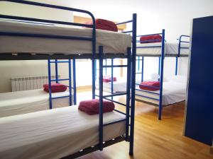 a group of bunk beds in a room at Albergue Segunda Etapa in Zubiri