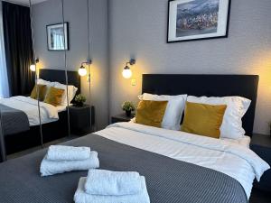 een slaapkamer met een groot bed met handdoeken erop bij Bansko St Ivan Rilski Residences in Bansko