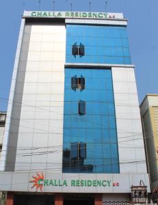 a building with a sign on the side of it at Challa Residency in Rājahmundry