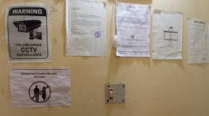 a wall with signs hanging on a wall at Ghosh homestay 8 in kolkata
