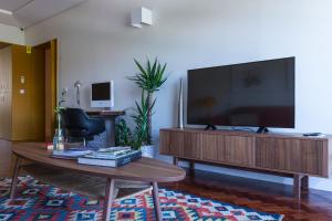 a living room with a large flat screen tv at República Bed & Breakfast in Lisbon