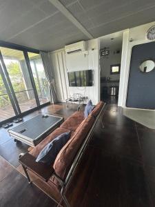 a living room with a couch and a table at Container Suite 75 in Nago
