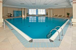 a swimming pool with a large tub in the middle of it at Rubin Wellness & Conference Hotel in Budapest