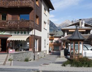 a building with a gazebo in the middle of a street at Casa Smith e Bice in Bormio
