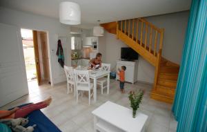 a man and a child standing in a living room at Résidence Odalys Le Domaine de l'Océan in Saint-Brévin-lʼOcéan