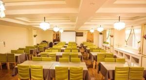 a large room with tables and yellow chairs at GreenTree Inn Xi'an Yanta District Dayanta Furongyuan Hotel in Xi'an