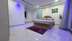 a bedroom with a bed and a purple rug at Elite stays in Rajiv Gandhi International Airport