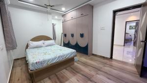a bedroom with a bed in a room with a mirror at Elite stays in Rajiv Gandhi International Airport