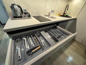 a drawer in a kitchen with utensils in it at Polyana Park House aparts in Polyana