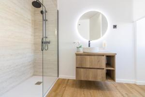a bathroom with a shower and a vanity with a mirror at Solar dos Arcos • Luxury Rural Retreat & Heated Po in Macieira da Lixa +19 photos
