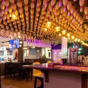 a bar with a bunch of bottles hanging from the ceiling at Indovu Wellness Retreat in Nairobi