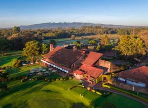 an aerial view of a house with a golf course at Indovu Wellness Retreat in Nairobi