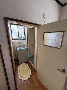 a bathroom with a sink and a toilet and a window at Sugi Mountain House in Myoko +1 photo