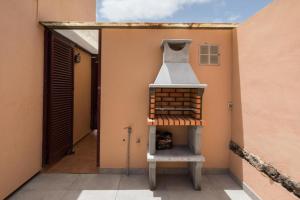 a pizza oven on the side of a house at Tajora House by Best Holidays Fuerteventura in La Oliva
