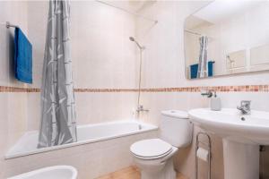 a white bathroom with a toilet and a sink at Tajora House by Best Holidays Fuerteventura in La Oliva
