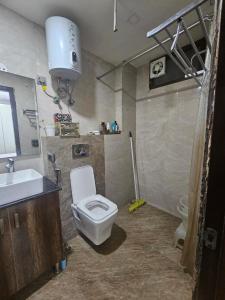a bathroom with a toilet and a sink at Independent Floor in Gurgaon