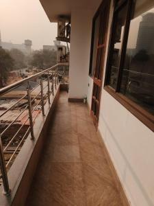 a corridor of a building with windows and a floor at Independent Floor in Gurgaon