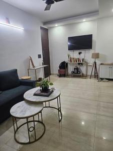 a living room with a couch and a table at Independent Floor in Gurgaon