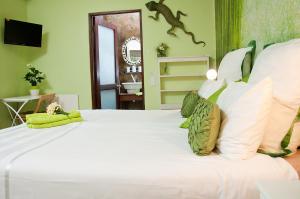 a bedroom with a large white bed with white pillows at a Vue Guesthouse in Somerset West