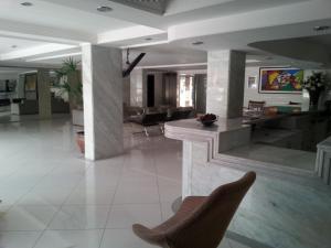 a living room with a couch and a chair in it at Manaíra Palace Residence in João Pessoa +37 photos