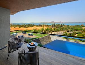 a view from the balcony of a villa with a swimming pool at Aria Resort & Spa in Nashik