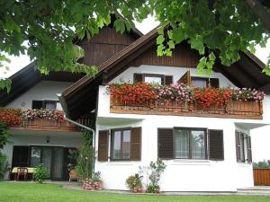 a house with two balconies with flowers on it at Pension Maria Wallner in Bad Gams