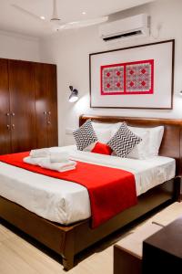 a bedroom with a large bed with a red blanket at Alankara Retreats Colombo 07 in Colombo
