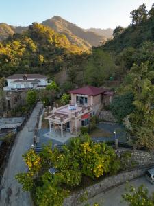 una vista aerea di una casa in montagna di The River Trail Cottage by The StayCationer a Rājpur