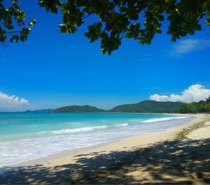 a view of a beach with mountains in the background at J home stay in Maluk +13 photos