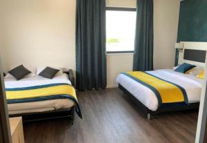 Ένα ή περισσότερα κρεβάτια σε δωμάτιο στο B&B HOTEL Brumath Bernolsheim