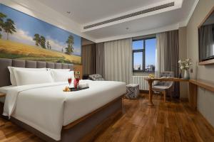 Ένα ή περισσότερα κρεβάτια σε δωμάτιο στο True Go Hotel Beijing New International Exhibition Center Capital Airport +24 φωτογραφίες