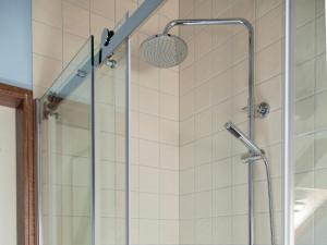 a shower in a bathroom with a glass door at De Wiede Blik in Westerbroek