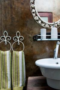 a bathroom with a sink and a mirror at a Vue Guesthouse in Somerset West