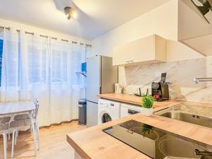 a kitchen with a sink and a counter top at Appartement lumineux à Royat in Royat
