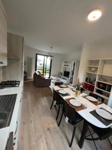 a kitchen and living room with a table and chairs at Residence Borgo Castello E1 Apartment in Argegno +6 photos