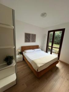 En eller flere senge i et værelse på Residence Borgo Castello E1 Apartment + 9 billeder