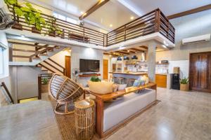 a living room with a couch and a kitchen at The Wander Nest Villas in Panglao Island