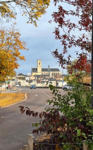 a view of a street with a car driving down a road at Le Colbert in Nevers