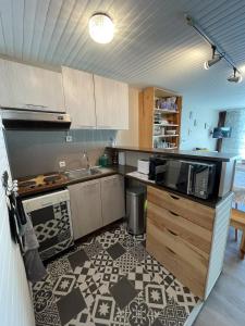 a kitchen with a sink and a counter top at Studio Buron des Gardes in Le Lioran